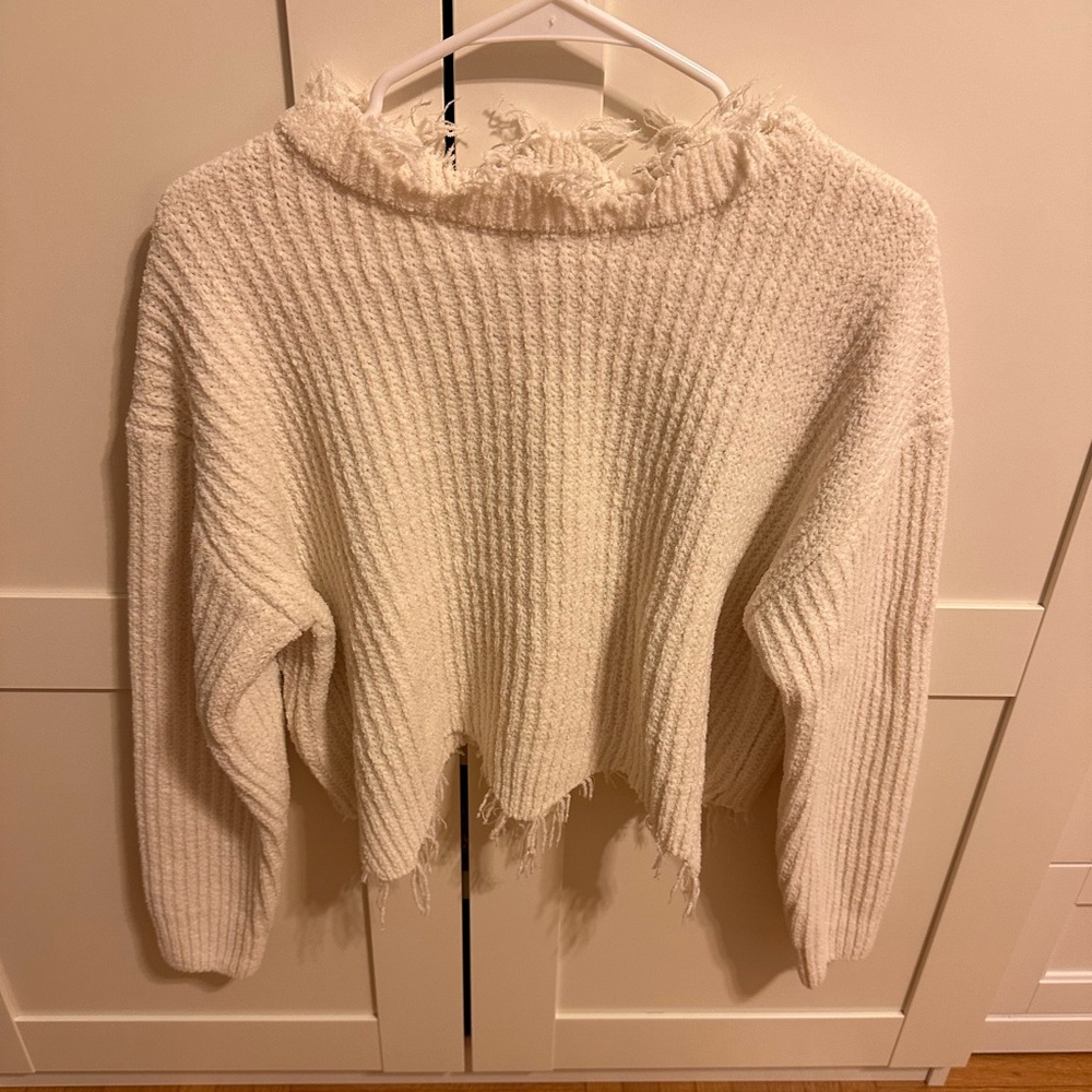 Distressed cream sweater